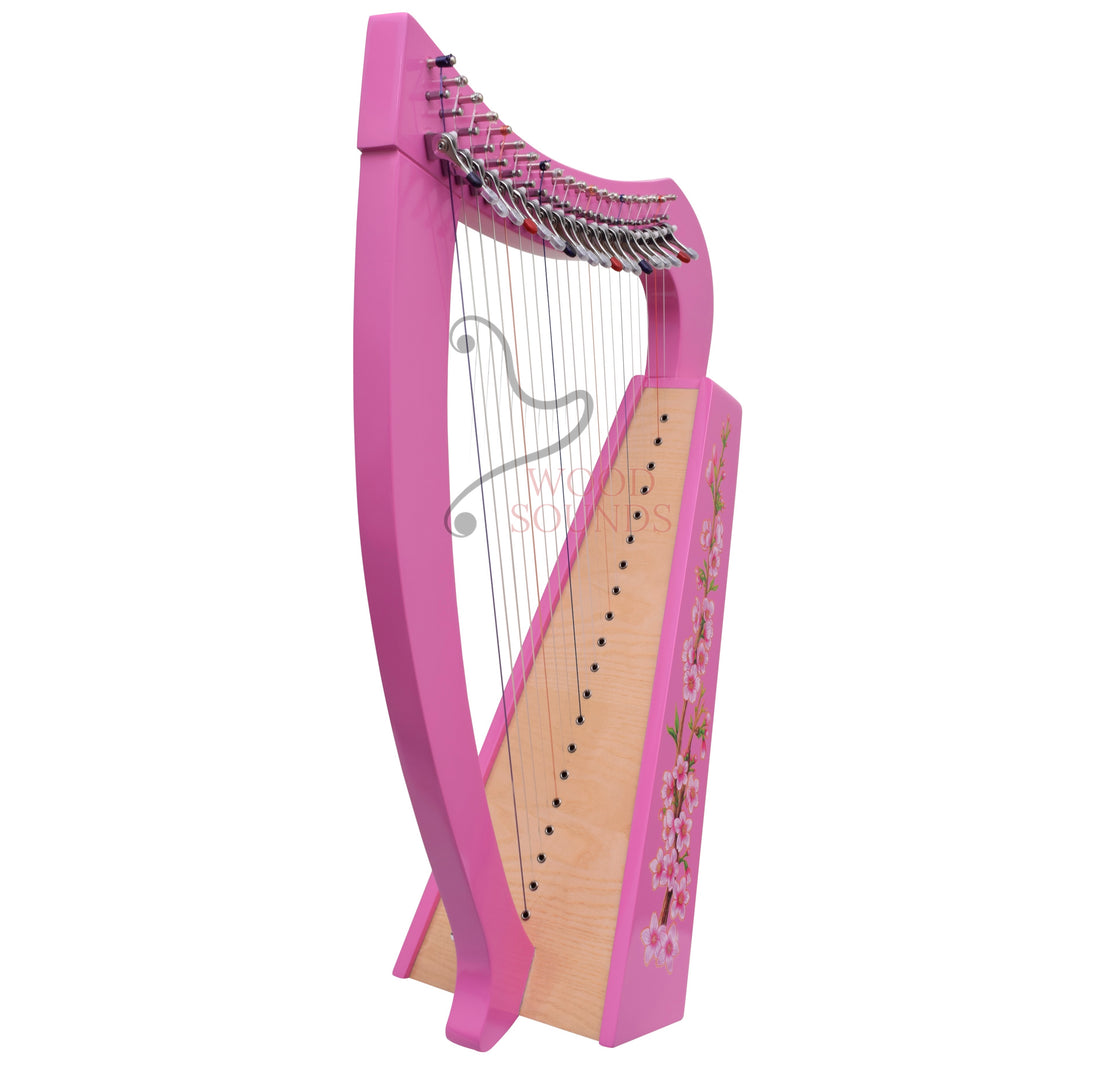 A pink harp-shaped wooden instrument with silver strings, decorated with cherry blossom illustrations on the side panel, shown on a plain white background.